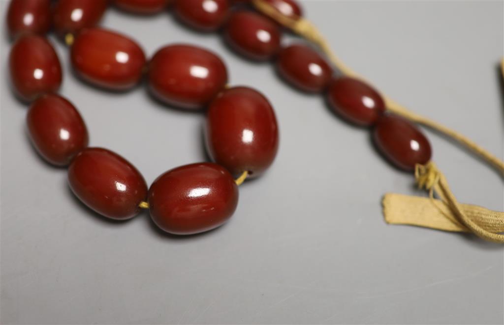 A single strand graduated simulated cherry amber necklace, 43cm, gross 75 grams.